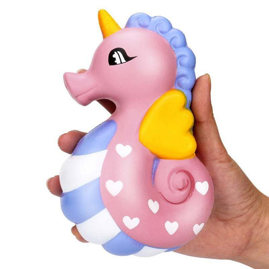 Cute seahorse decompression toy for children with a pink and blue design, featuring heart patterns and a yellow fin.