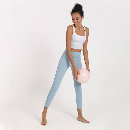 Women’s yoga suit with white top and light blue leggings.