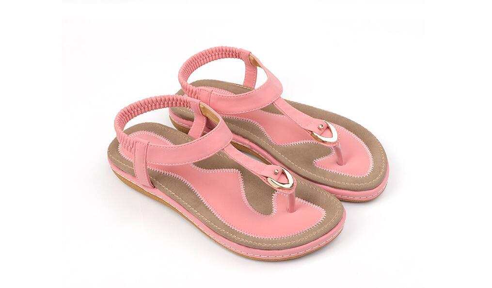 Fashionable pink summer sandals for women with low heel and ankle strap.