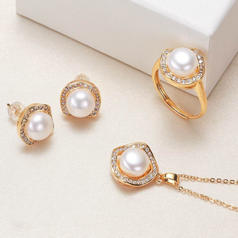 Pearl necklace, ring, and earrings set with gold accents.