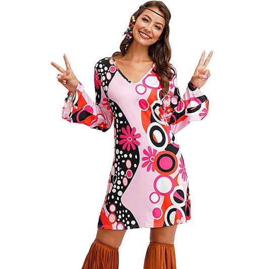 Hippie print dress with vibrant circular patterns, mid-length, worn by model showing peace sign.