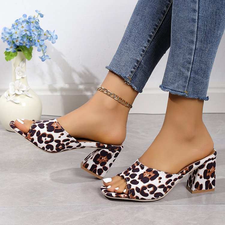 Leopard square toe high-heeled sandals with chunky heel for women, styled with ankle jeans.