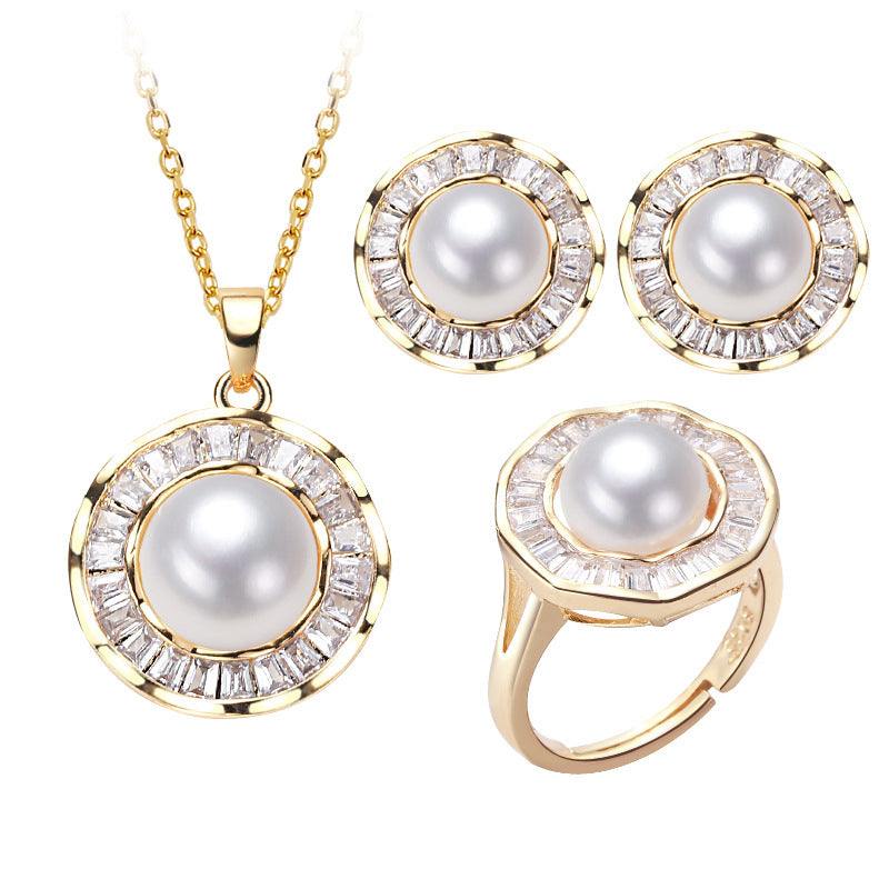 Pearl necklace, ring, and earrings set with gold accents.