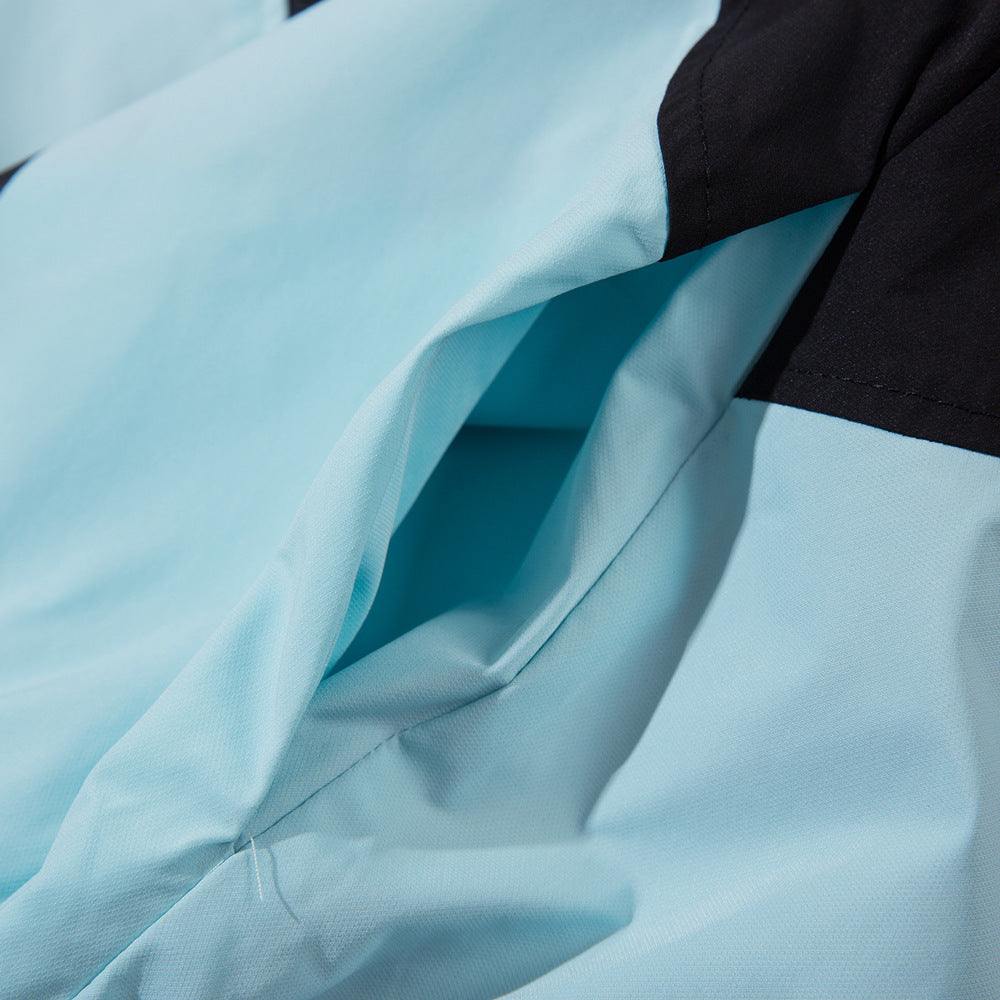 Close-up of sun-protective blue wind coat fabric showing a pocket detail.