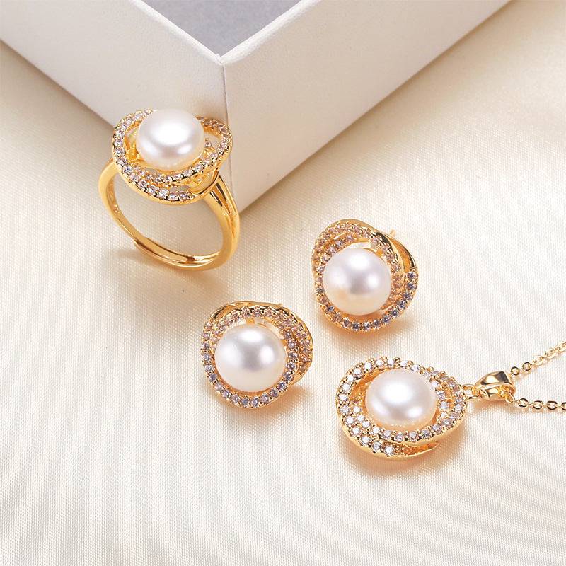 Elegant pearl necklace, ring, and earrings set with gold accents.